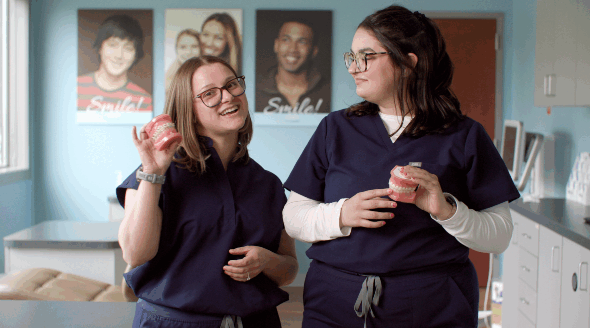 Orthodontic team members holding dental models in the office