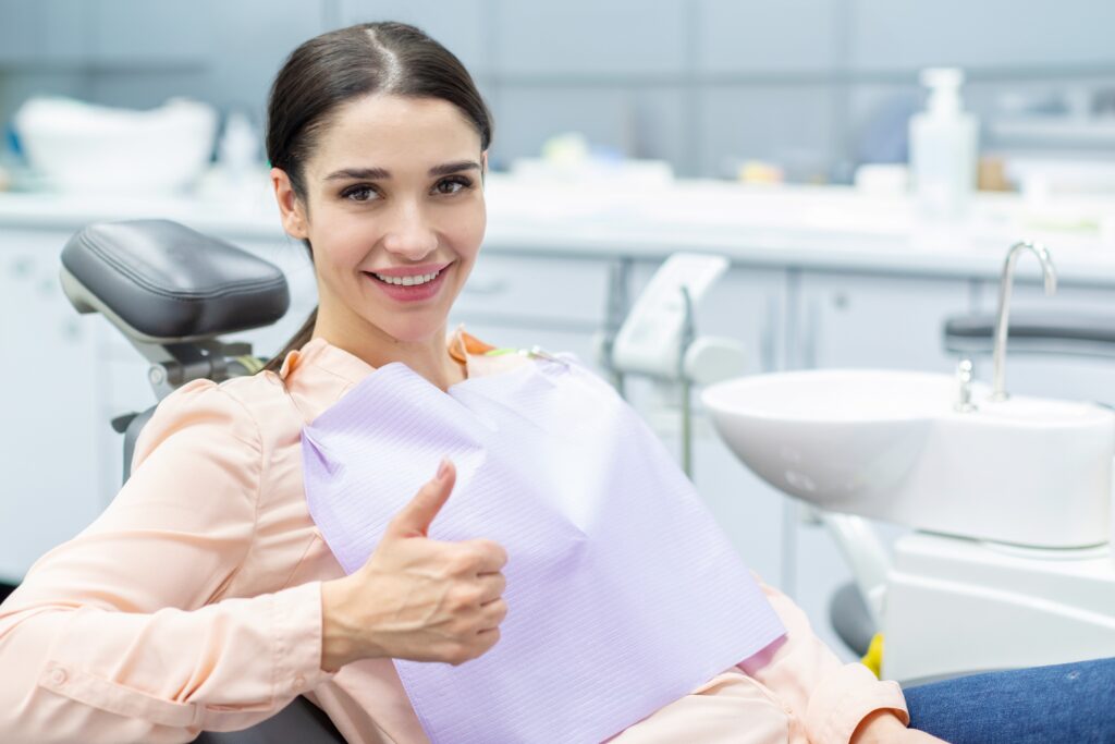Smiling patient with replacement retainers to help maintain orthodontic results